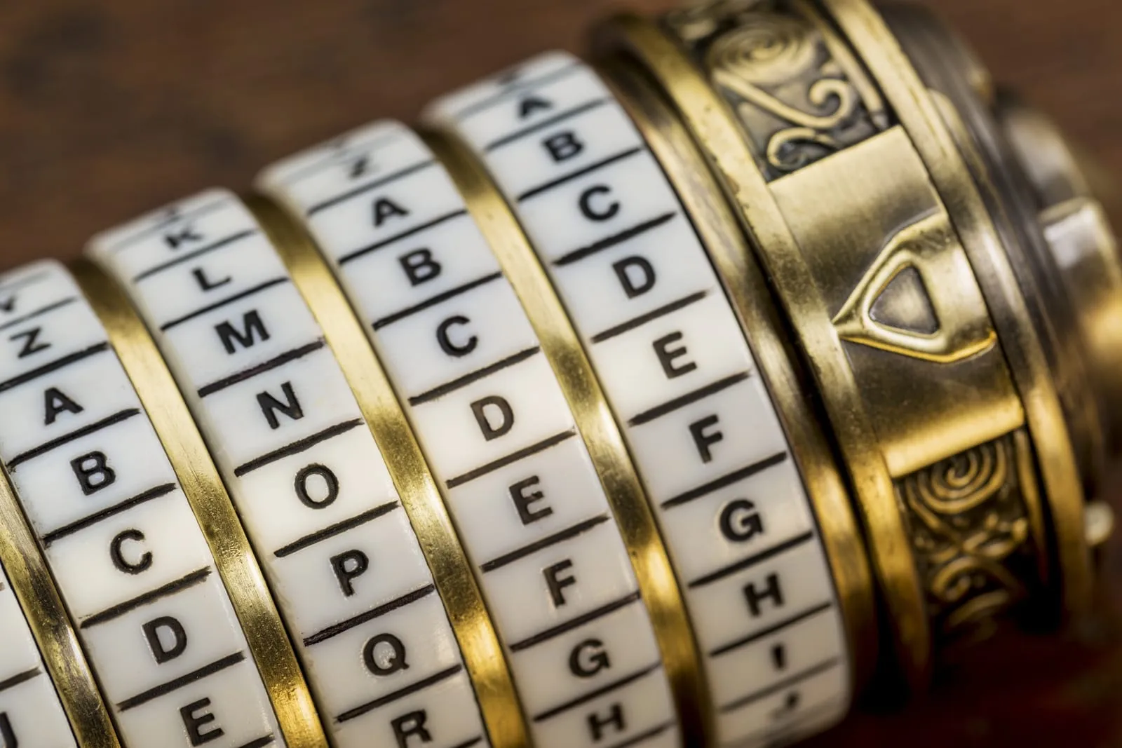 Close-up of a brass combination cylinder with rings of letters
