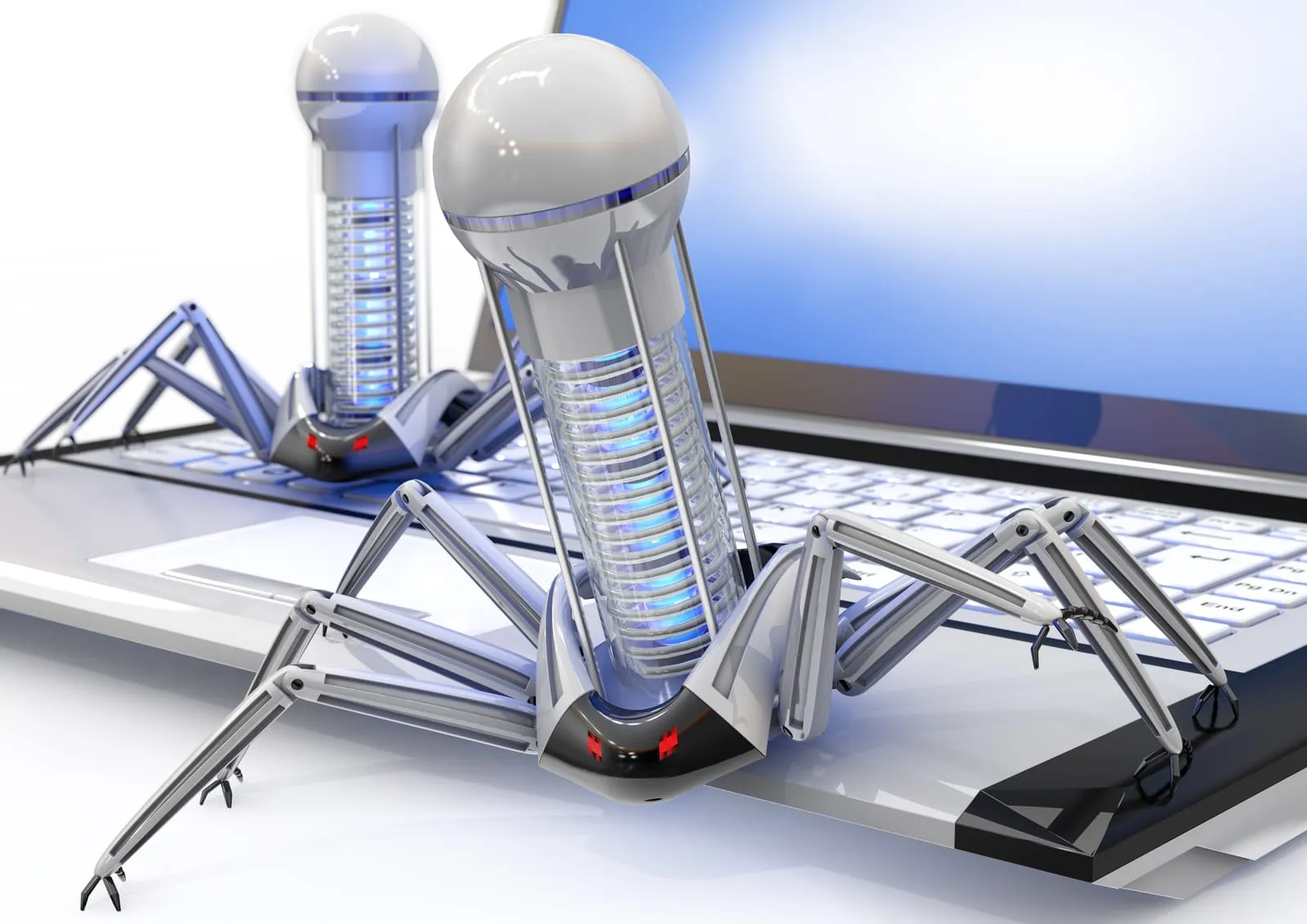 Metallic robotic insect resting on a computer keyboard