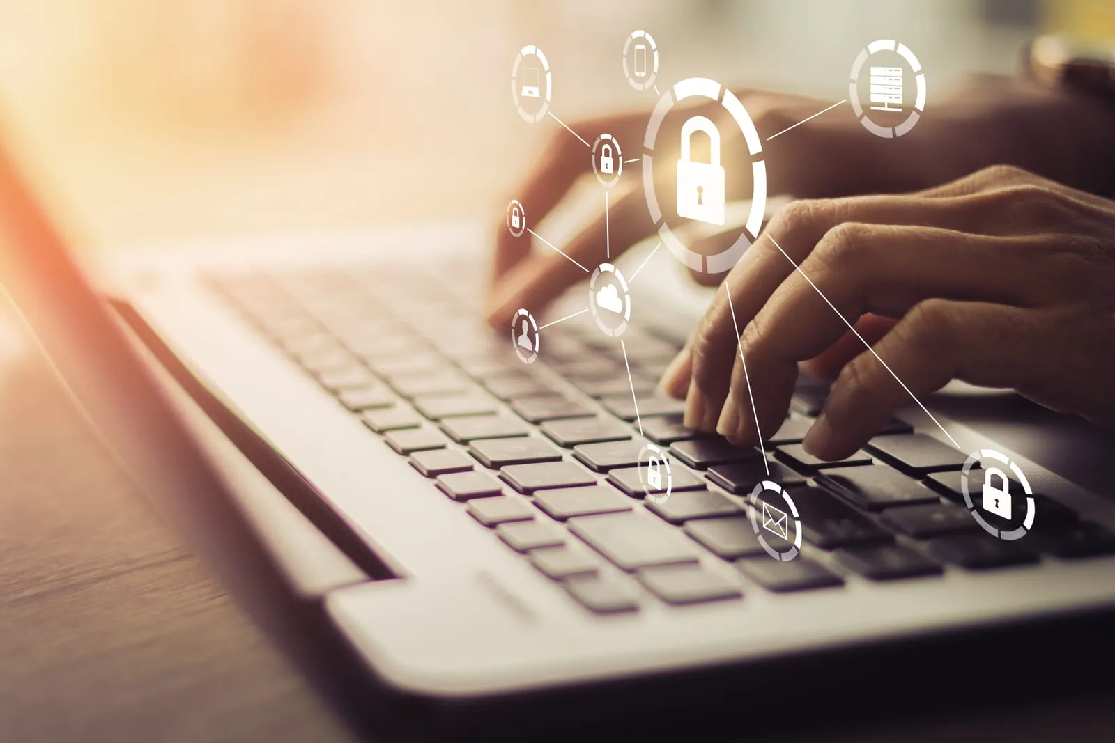 Hands on a laptop keyboard with padlock and security icons overlaid