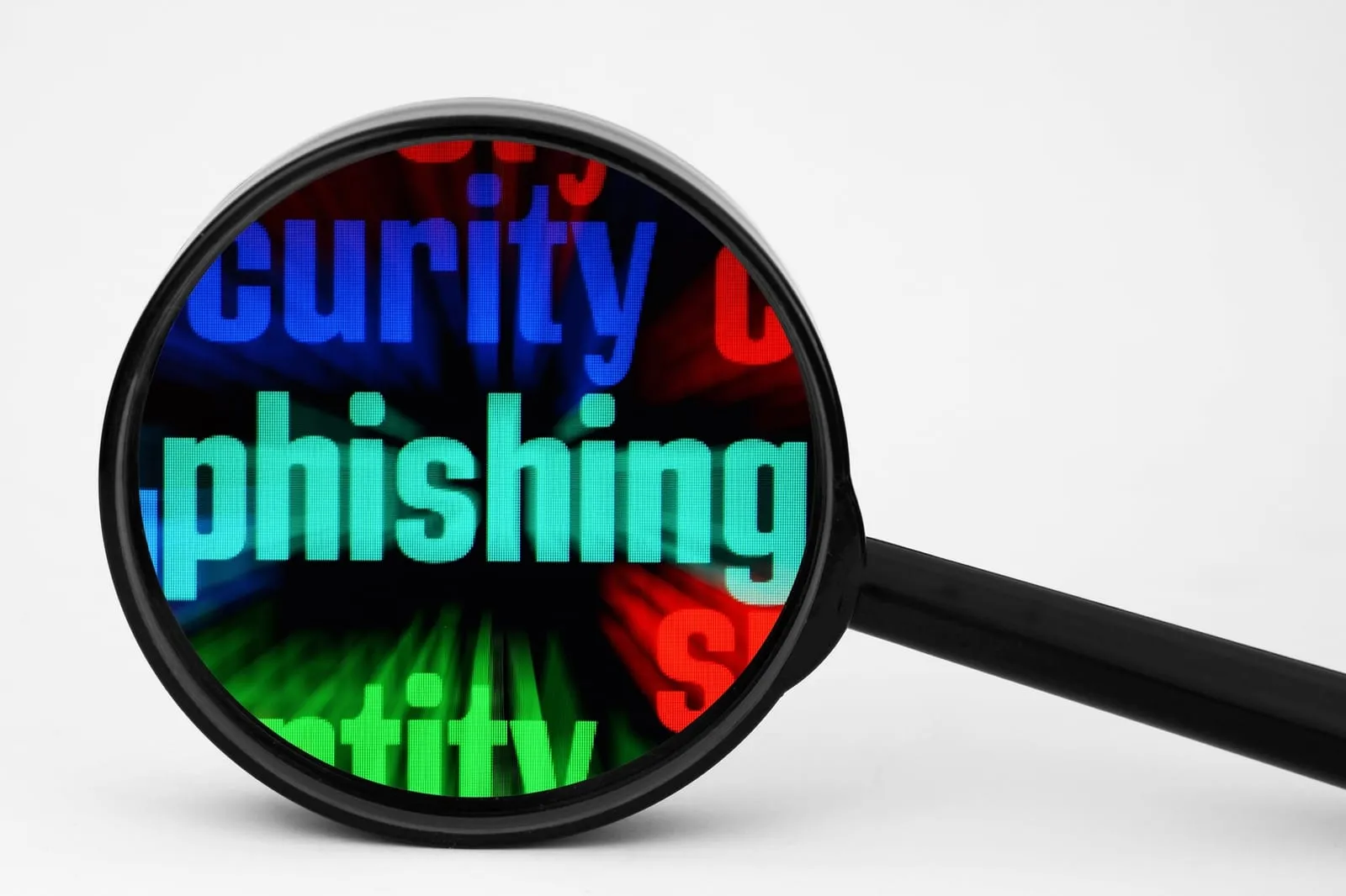 Black magnifying glass enlarging the word phishing on a background of coloured text
